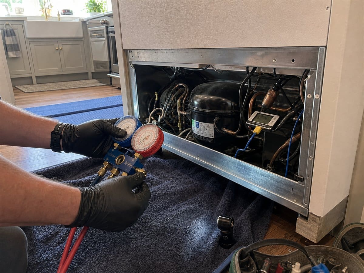 Manifold gauges connected during built-in refrigerator sealed-system diagnosis